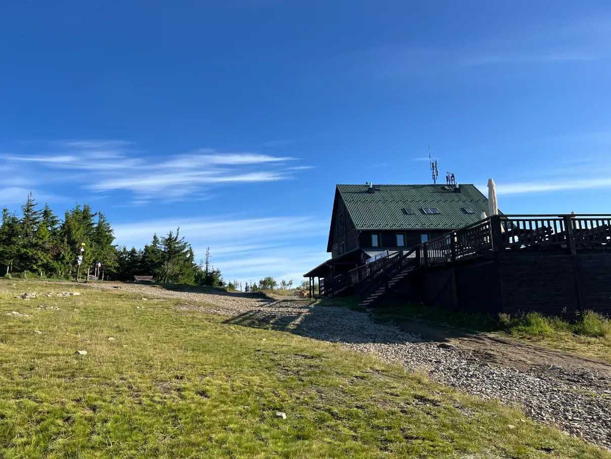 PTTK mountain shelter on Skrzyczne summit with green roof and antenna masts in Beskid Śląski