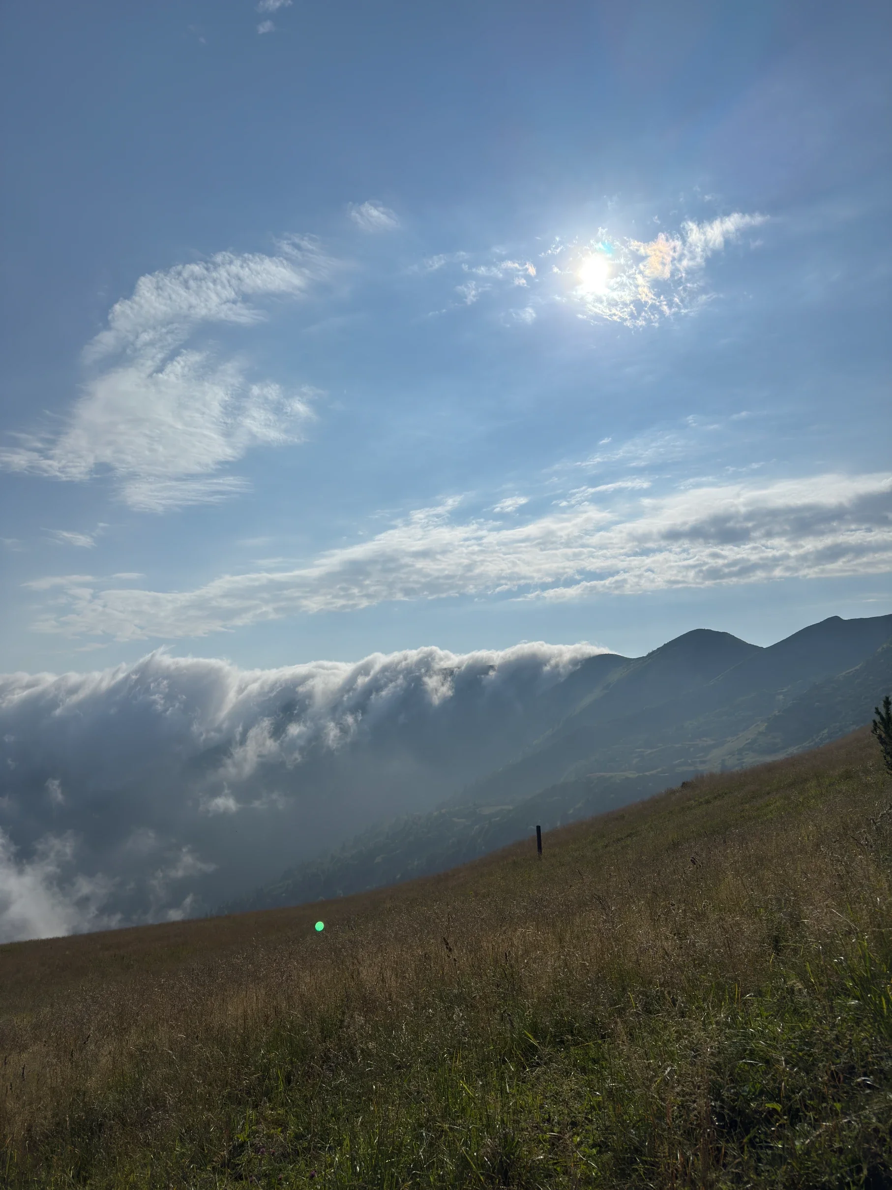 An avalanche of clouds over the ridge of Malá Fatra against the sun